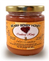Creamed honey mixed with natural cranberries .